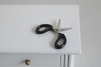 1:12 scale miniature stationery scissors with black handles and silver blades, shown on a white desk