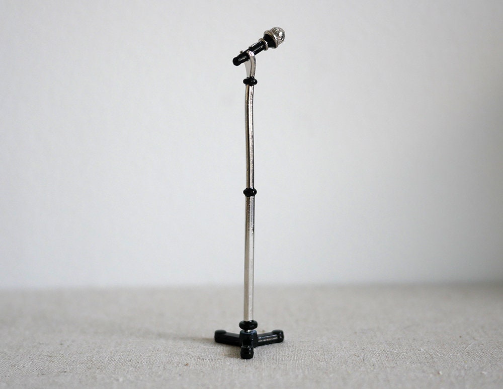 1:12 scale miniature black microphone with tall silver stand and tripod base, shown against a white wall