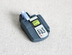 1:12 scale miniature credit card machine in gray with keypad, screen and paper roll, non working, on linen