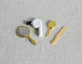 1:12 scale miniature hair dryer in white with gold hand mirror, brush and comb, set of 4, shown on linen fabric