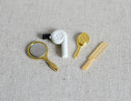1:12 scale miniature hair dryer in white with gold hand mirror, brush and comb, set of 4, shown on linen fabric