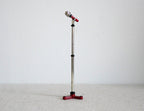 1:12 scale miniature microphone with tall silver stand and red tripod base, shown standing against a white background