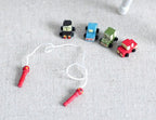 1:12 scale miniature wood toy cars in assorted colors with a red handled jump rope, shown on a gray surface