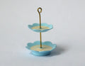 1:12 scale miniature 2 tier serving stand in light blue with scalloped plates, cream centers and gold loop handle