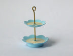 1:12 scale miniature 2 tier serving stand in light blue with scalloped plates, cream centers and gold loop handle