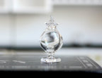 1:12 scale miniature clear glass footed candy jar with pointed lid, shown on a black kitchen counter