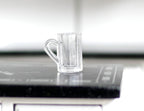1:12 scale miniature clear glass beer mugs with handles, set of 2, one mug shown on a black counter