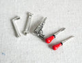 1:12 scale miniature metal hand tool set of 5 with red handled screwdrivers, wrench and hex keys, laid out on white fabric
