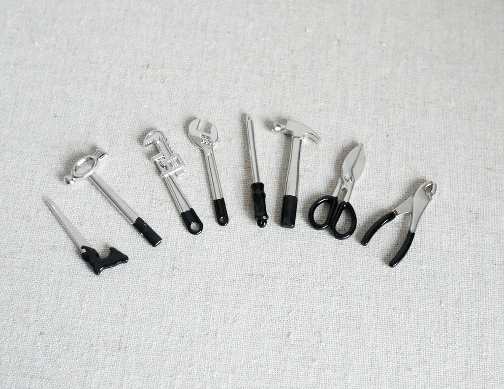1:12 scale miniature hand tools in black and silver, set of 8, hammer, saw, pliers and wrenches laid out in a row