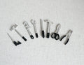 1:12 scale miniature hand tools in black and silver, set of 8, hammer, saw, pliers and wrenches laid out in a row