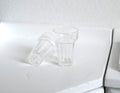1:12 scale miniature clear tumbler glasses with faceted base, set of 2, one upright and one on its side on a counter