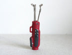 1:12 scale miniature red golf bag with 3 silver clubs, set of 4, standing upright on a white background