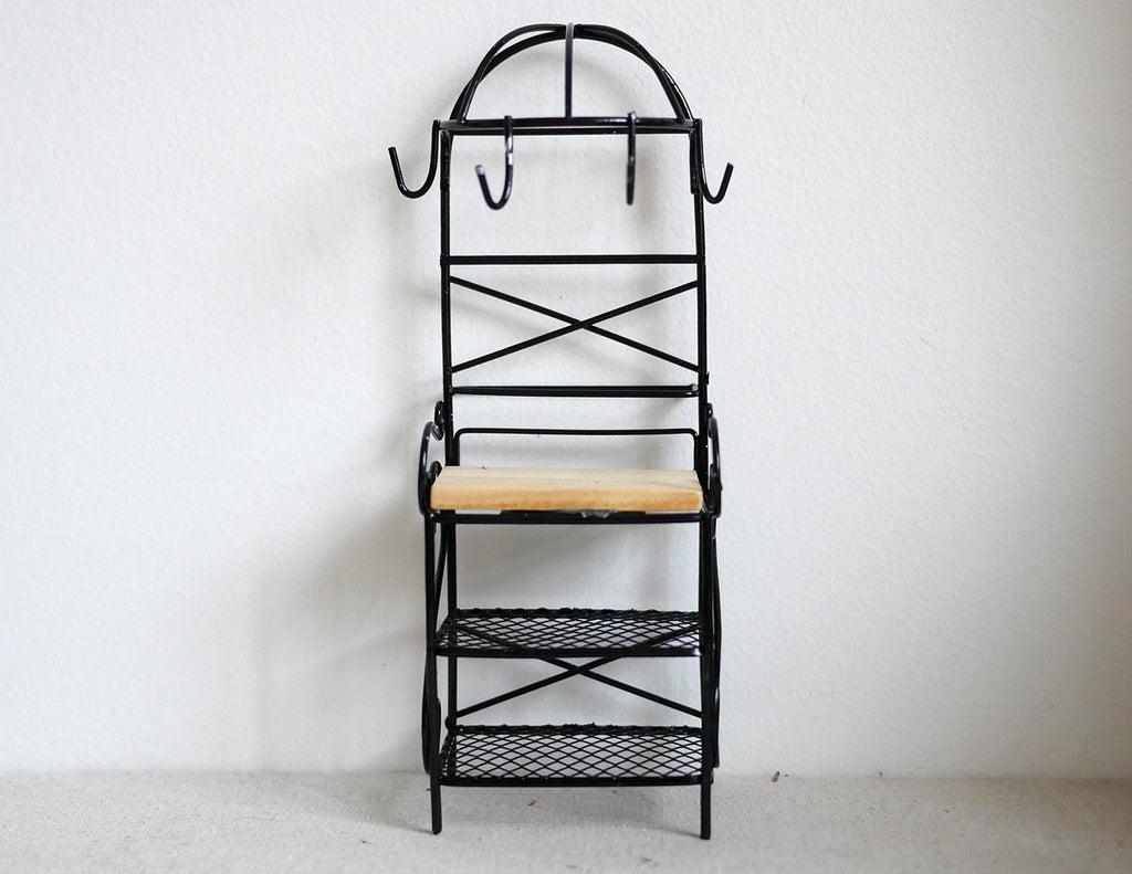 1:12 scale miniature metal baker's rack in black with arched top, hooks, wood shelf and wire shelves