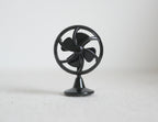 1:12 scale miniature non working metal vintage style desk fan in black with round cage, shown on a white surface
