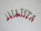 1:12 scale miniature metal hand tool set with red handles, set of 8, hammers, wrenches and pliers on gray fabric