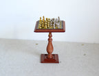1:12 scale miniature chess table on a turned wood pedestal base with gold and silver metal chess pieces