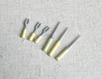 1:12 scale miniature metal BBQ grill tools, set of 6 with pale yellow handles, laid out on linen fabric
