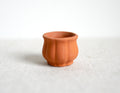 1:12 scale miniature clay flower pot with fluted sides, unglazed terracotta, shown empty on a white surface