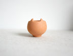 1:12 scale miniature terracotta clay planter with cut out rim, round body, shown empty on a white surface