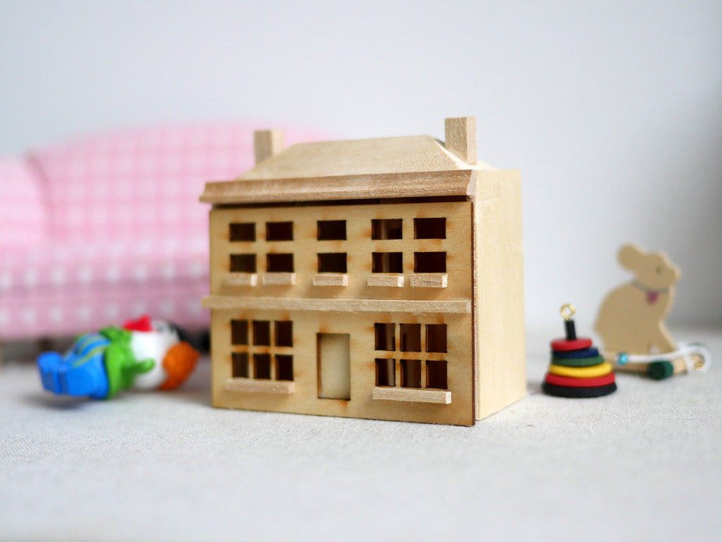 1:144 scale miniature unpainted wood house model with removable front, three story facade, shown with tiny toys