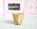 1:12 scale miniature natural woven basket with tall handle, tapered shape, shown on a white surface