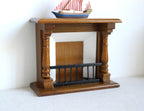 1:12 scale miniature wood fireplace in walnut with white firebox and black grate, shown with a model boat on the mantel