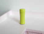 1:12 scale miniature metal insulated water bottle with cap in lime green, shown standing on a white surface
