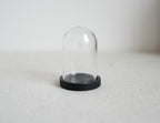 1:12 scale miniature glass dome with black wood base, clear bell jar cloche, shown empty on a white surface