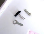 1:12 scale miniature corkscrews and bottle opener, set of 3, silver metal with one black handle, on a white surface