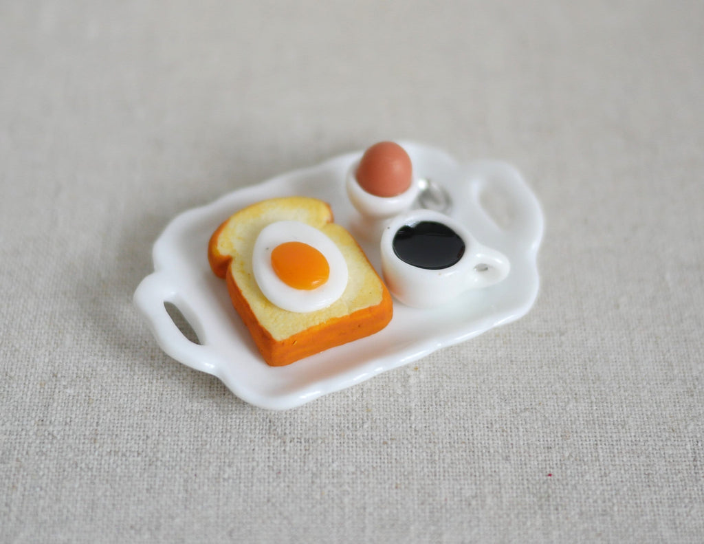 1:12 scale miniature breakfast tray set with fried egg on toast, boiled egg in cup and black coffee on a white tray