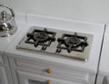 1:12 scale miniature metal 2 burner cooktop with black grates, silver finish, shown on a white kitchen counter