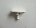 1:12 scale miniature wood wall shelf in white with curved bracket, half round shelf mounted on a white wall