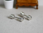 1:12 scale miniature metal dumbbells in silver with ribbed ends, set of 2, shown on a gray floor
