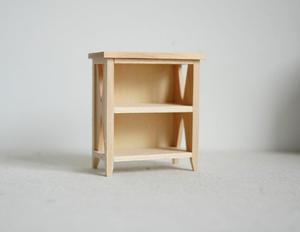 1:12 scale miniature unpainted wood bookshelf with 3 shelves and cross braced sides, shown against a white background