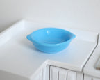 1:12 scale miniature large salad bowl with handles in light blue, single, shown on a white kitchen counter