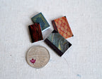 1:12 scale miniature children's books that open with patterned covers, set of 4, shown beside a coin