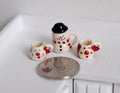 1:12 scale miniature ceramic Christmas snowman jar with black top hat lid and 2 mugs, set of 3, beside a coin