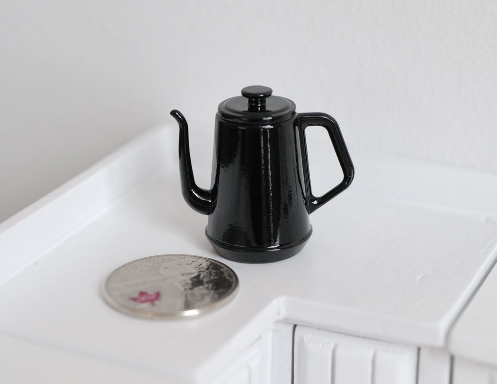 1:12 scale miniature metal gooseneck kettle in black with lid, shown beside a coin on a white counter