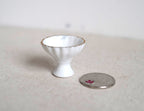 1:12 scale miniature ceramic footed serving bowl in white with a fluted rim and gold edge, shown beside a coin for scale