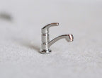 1:12 scale miniature chrome single lever faucet with a gooseneck spout, shown standing on a white surface