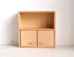 1:12 scale miniature unpainted wood sideboard with 2 doors, gold handles and open top shelf, on a white surface