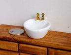 1:12 scale miniature ceramic bathroom vessel sink with gold faucet, round white basin, shown on a wood vanity top