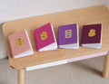 1:12 Scale Miniature Books That Open, Pastel Covers with Gold Emblems, Set of 4, 13/16 inch tall, DIY Dollhouse Supply