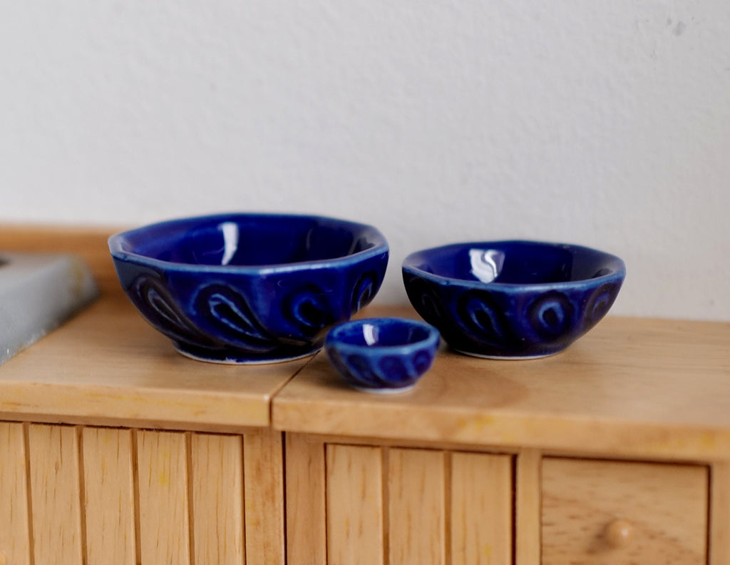 1:12 scale miniature ceramic bowls in glossy cobalt blue, set of 3 graduated sizes, shown on a wood sideboard