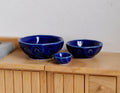 1:12 scale miniature ceramic bowls in glossy cobalt blue, set of 3 graduated sizes, shown on a wood sideboard