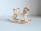 1:12 scale miniature unpainted wood rocking horse with seat and handle, natural finish, shown on a white surface