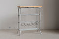 1:12 scale miniature white metal baker's rack with wood top shelf, wire shelves and a bottle rack, on a beige floor