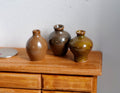 1:12 scale miniature ceramic jug vases in glossy brown, assorted shapes, set of 3, shown on a wood dresser