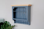 1:12 scale miniature wood kitchen wall plate rack in blue gray with slatted back and natural top, on a wall