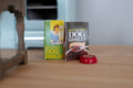 1:12 scale miniature dog food packs with red food bowl, set of 3, shown on a wood floor